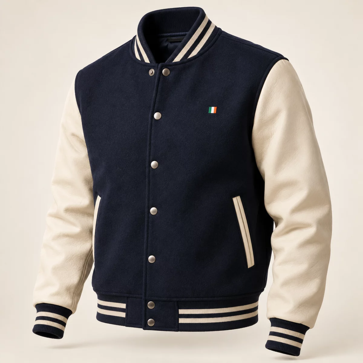 Tricolour Varsity Jacket Navy and cream Tricolour Varsity Jacket design mock-up: Navy body cream sleeves; subtle tricolour chest tab; snap front