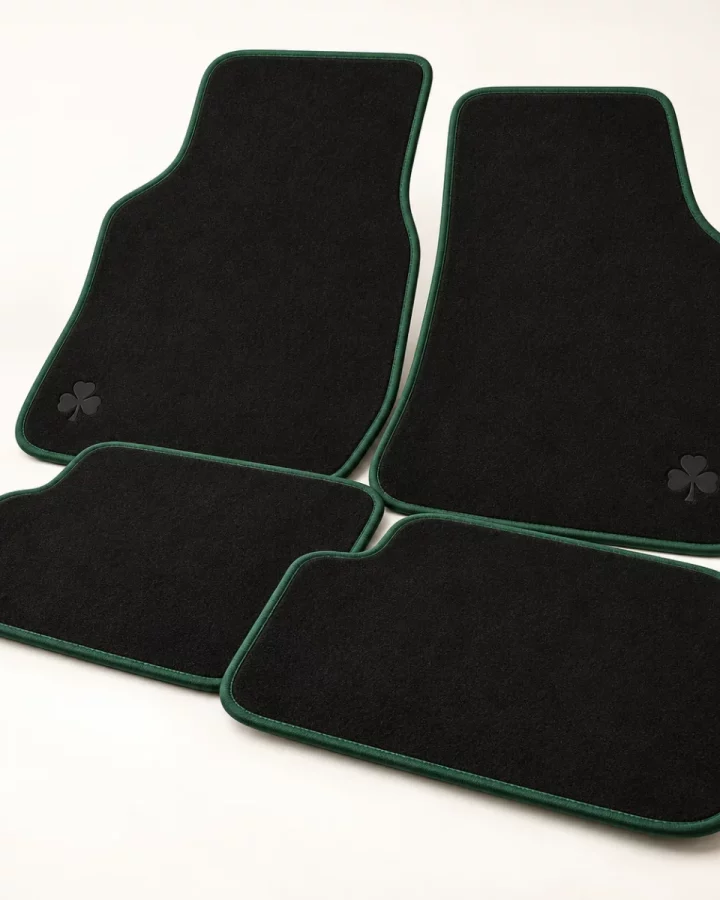 Black Shamrock Car Mat Set design mock-up: Black mats; tonal shamrock; forest-green edge piping; fitment not specified