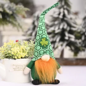 Two green gnome designs together on a shelf